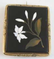 A late 19th century yellow metal pietra dura brooch, of rectangular form, depicting a white lily