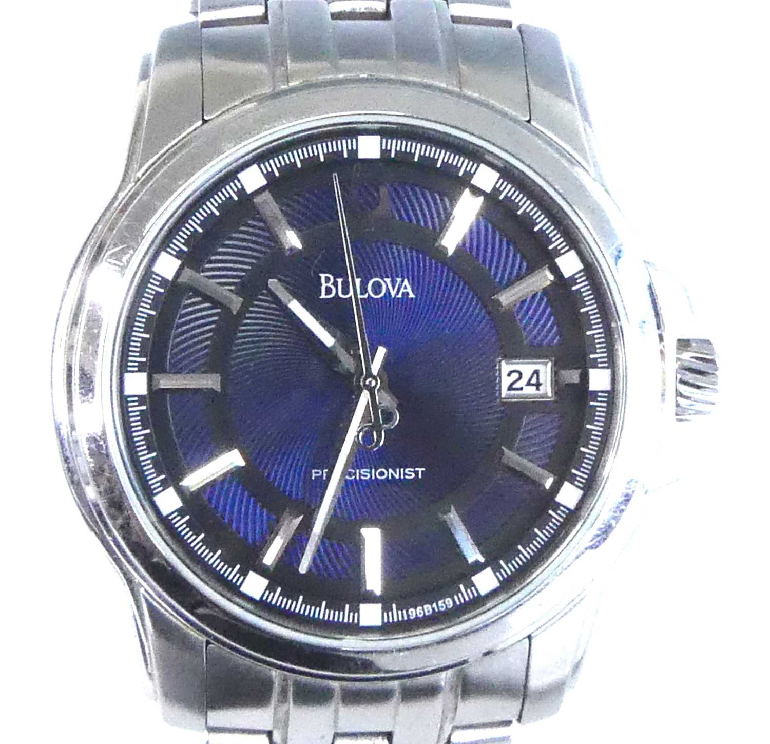 A stainless steel Bulova Precisionist quartz wristwatch, having a round blue baton dial and date