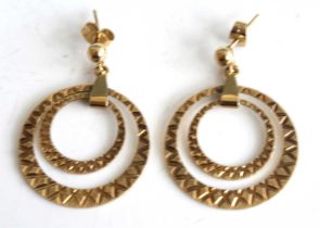 A pair of 9ct yellow gold double open circular drop earrings, each with a diamond cut finish and