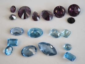 A collection of loose vari-cut blue topaz and mystic topaz stones, the smallest blue topaz measuring