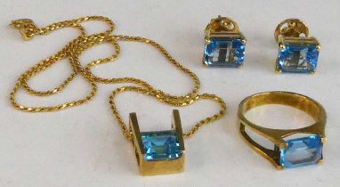 A yellow metal blue topaz suite comprising a pair of blue topaz stud earrings, each with a