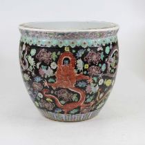 A Chinese pottery jardiniere in the Famille Noir pattern, enamel decorated with flowers and dragons,