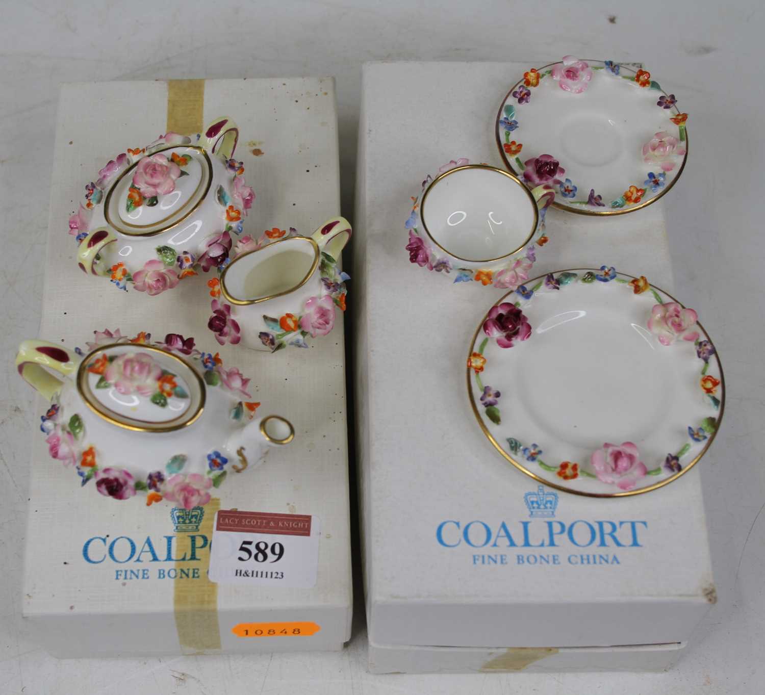 A Coalport miniature floral encrusted bachelor's tea service The saucer is cracked.Some small losses