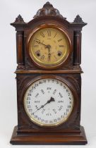 An E. Ingraham & Co. walnut cased twin dial calender shelf clock, of architectural form, the upper