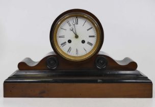 A Victorian walnut and ebonised drum head mantel clock, having an enamelled dial with Roman numerals
