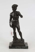 After Michaelangelo, a bronzed metal figure of David, modelled standing on plinth and further