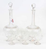 A pair of Edwardian cut glass decanters and stoppers, of onion shape, h.27cm, together with a set of