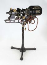 An early 20th century black lacquered and brass microscope slide projector on telescopic cast iron