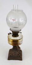 A 20th century oil lamp having a clear glass chimney and etched frosted and clear glass shade to