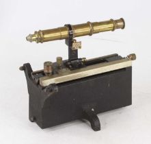 An early 20th century lacquered brass and cast iron Vernier type monocular microscope, the scale