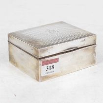 A George V silver table cigarette box, having engine turned hinged lid with monogrammed cartouche,