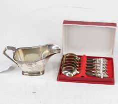 An Art Deco silver sauceboat, having a folded rim and angular handle, 4.7oz; together with a set