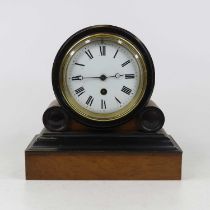 A Victorian walnut and ebonised cased drum head mantel clock, having an enamelled dial with Roman