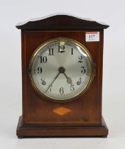 An Edwardian mahogany and inlaid mantel clock, the silvered dial with Arabic numerals and twin