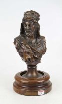 A cast bronze head and shoulders portrait bust of an Arab, mounted on a turned mahogany base, height