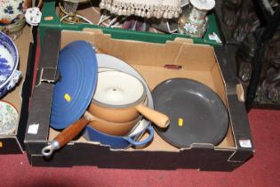A box of Le Creuset enamel cast iron cookware