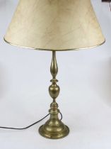 A brass three light table lamp having a knopped column on circular base, height including shade