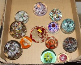 A collection of Victorian and later glass paperweights, to include dimpled amber and clear glass