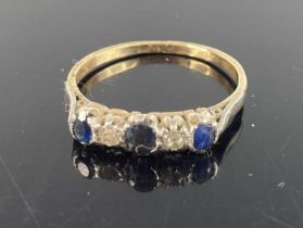 A yellow metal sapphire and diamond five stone half hoop ring (centre blue stone not testing as