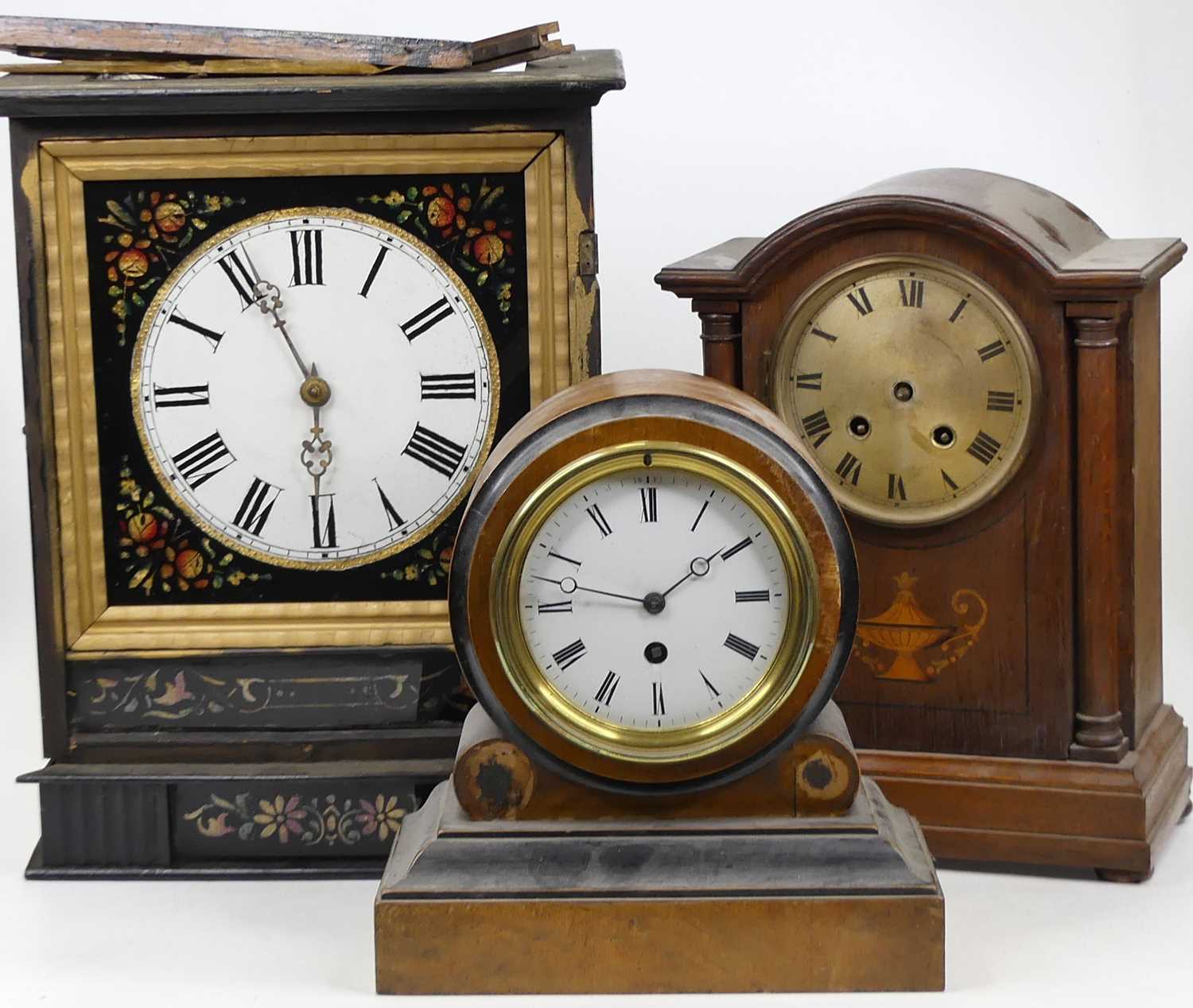 A Victorian walnut and ebonised cased drum head mantel clock, having an enamelled dial with Roman