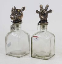 A pair of novelty glass decanters, one stopper in the form of a giraffe's head, the other in the