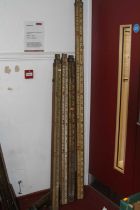 A collection of four wooden, brass mounted and polychrome painted telescopic surveyor's measures,