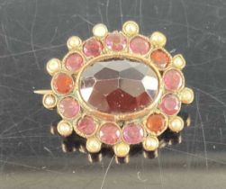 A late Victorian yellow metal, amethyst, garnet and seed pearl set oval brooch, 7.5g, 27mm