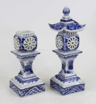 A pair of oriental style blue & white porcelain tea light holders in the form of pagodas, height