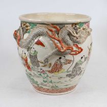 A Chinese pottery jardiniere decorated with children playing and with applied high relief dragon,