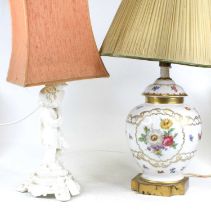 A blanc de chine porcelain table lamp in the form of a cherub holding a cornucopia, height including