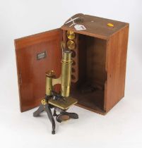 A 19th century lacquered brass monocular microscope having lacquered brass platform with swing