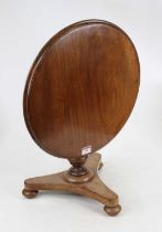 A Victorian mahogany apprentice breakfast table having a hinged circular top on turned baluster