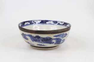 A Chinese Nan King bowl underglaze decorated with a landscape, bearing a four character mark to