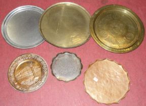 An Arts & Crafts copper tray, of shaped circular form, having floral engraved and pokerwork