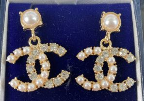 After Coco Chanel pair of gilt metal and paste set ear pendants
