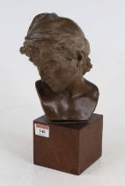 A painted pottery head & shoulders portrait bust of a boy, mounted on square hardwood plinth, height