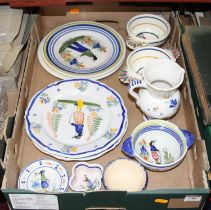 A collection of Quimper pottery to include a twin handled porringer, plates, and a jug