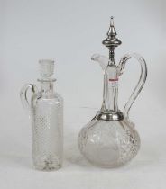 A continental cut glass claret jug having white metal mounted stopper and cut glass body, etched