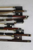 A collection of six vintage full size violin bows