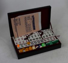 A Mah jong set in black faux leather case, width 28cm (not checked for completeness)