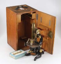 An early 20th century American lacquered brass and iron monocular microscope having a rack and