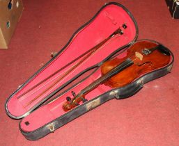 A cased violin having a two piece maple back and ebonised finger board, together with two bows