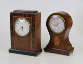 An Edwardian mahogany and inlaid balloon shaped mantel clock, having a later quartz movement and