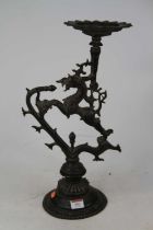 An eastern bronze candlestick, of zoomorphic form, height 47cm