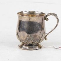 A George V silver christening tankard, of bell shape, with acanthus capped C-scroll handle and