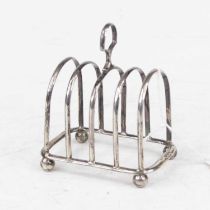 A George V silver toast rack, having four arched divisions, with loop handle and on ball feet, 2oz