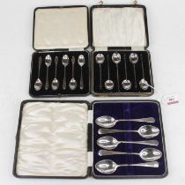 A set of George V silver coffee bean spoons, in fitted leather case; together with another set of