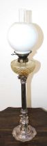 A Victorian oil lamp having a clear glass chimney, associated opaline glass shade, on Hinks No. 2