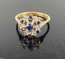An 18ct gold blue sapphire and diamond point set flower head cluster ring, setting dia. 12mm, 3.