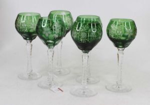 A set of six cut glass wine hocks each having a green bowl etched with vines on faceted stem and